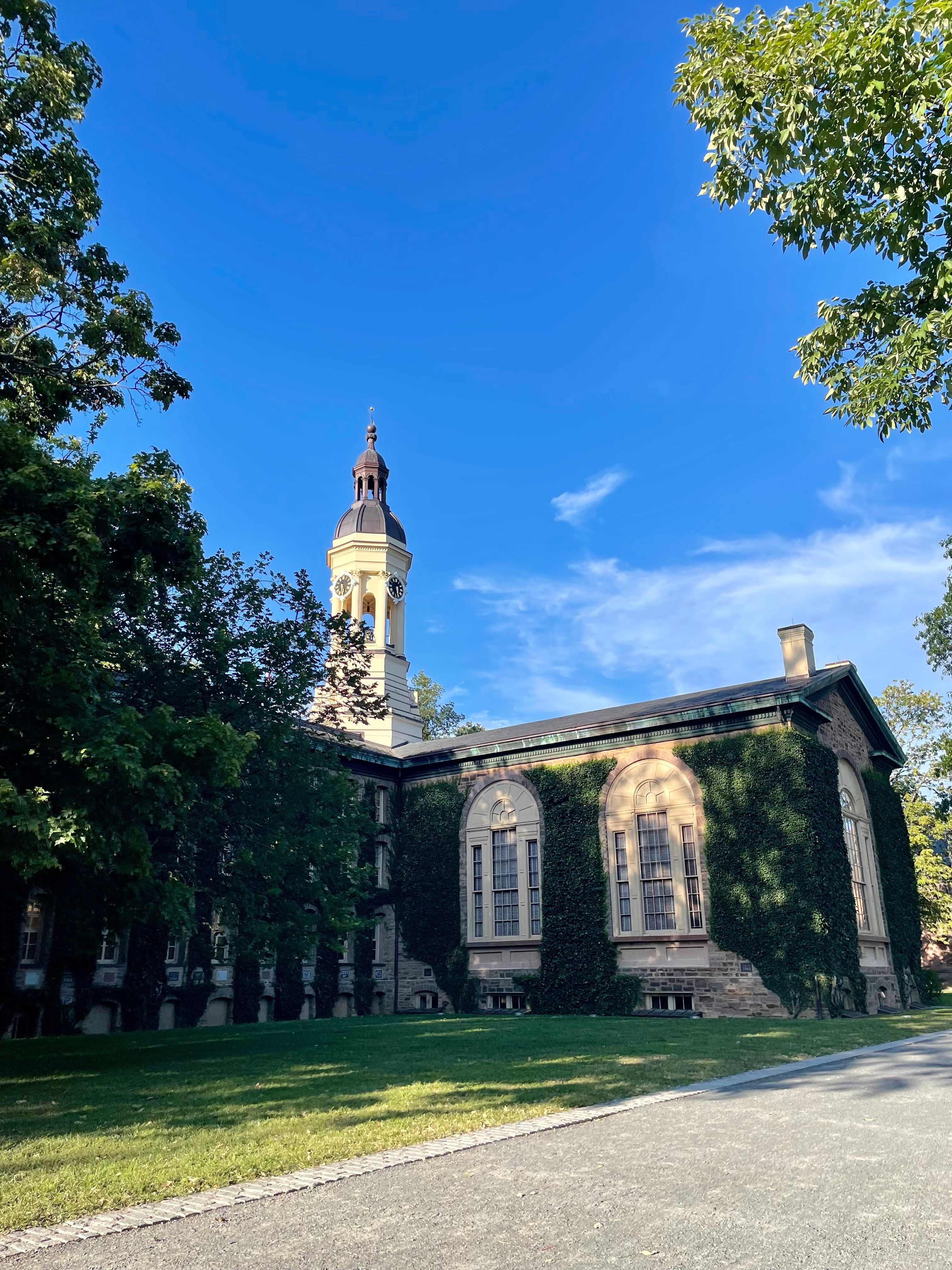 photo of part of the back of Nassau Hall during a fall day with bright blue sky.